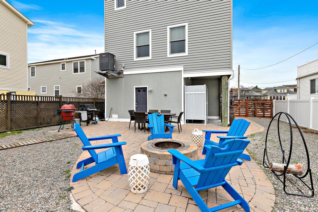 Backyard fire pit with Adirondack chairs